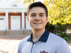 Sophomore Carter Dees stands in front of Auburn landmark, Langdon Hall.