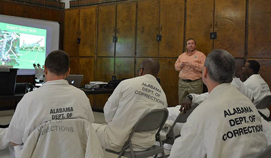 students taking a class in prison